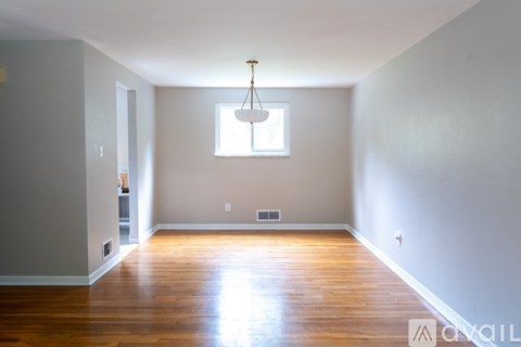 A room with wooden floors and a window.