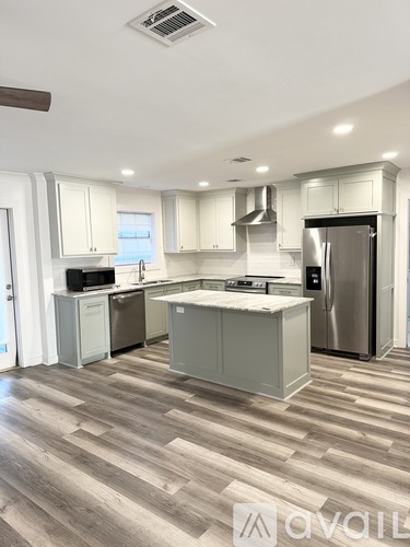 A kitchen with a refrigerator, stove, and oven.
