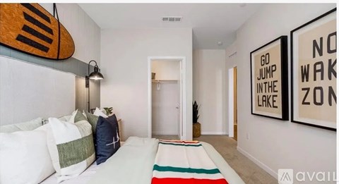 A bedroom with a surfboard hanging on the wall and a rug on the floor.