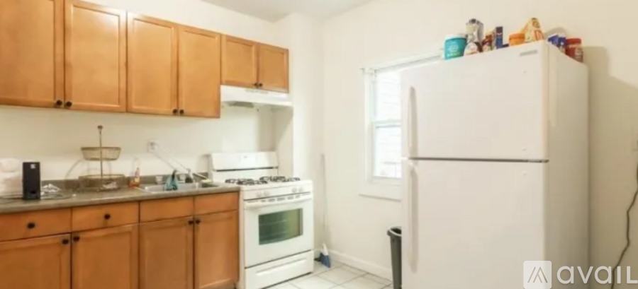 A kitchen with wooden cabinets and a white fridge.