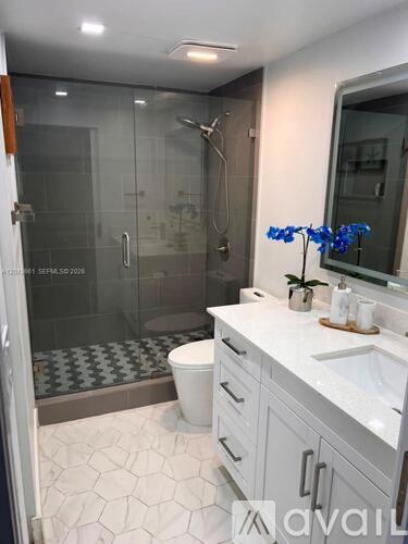 A bathroom with a walk-in shower and a toilet.