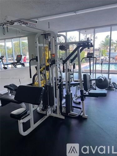 A gym with a variety of equipment including a leg press machine.