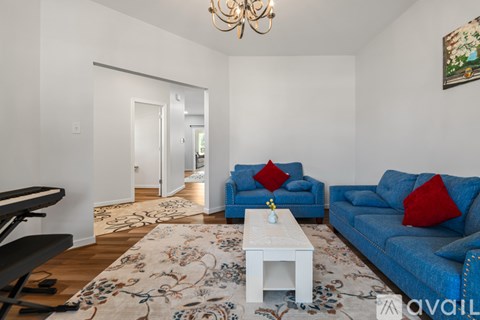 A living room with a piano and a sofa.