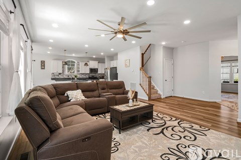 A living room with a brown sectional sofa and a coffee table.