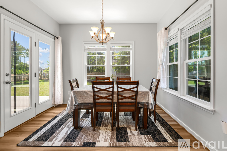 A dining room with a table set for four.