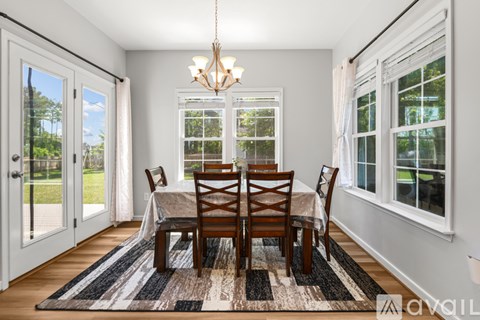A dining room with a table set for four.
