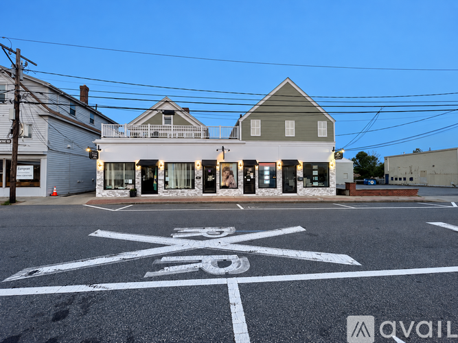 A bike lane is painted on the street in front of a building.