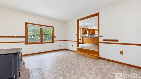A living room with a television and a large window.