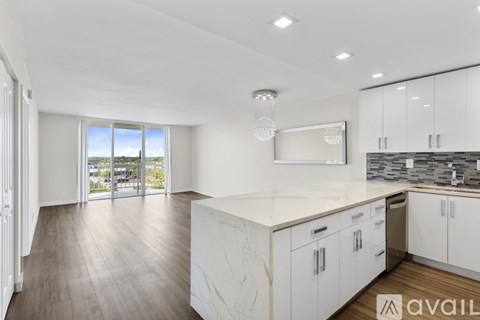 A modern kitchen with white cabinets and a large island.