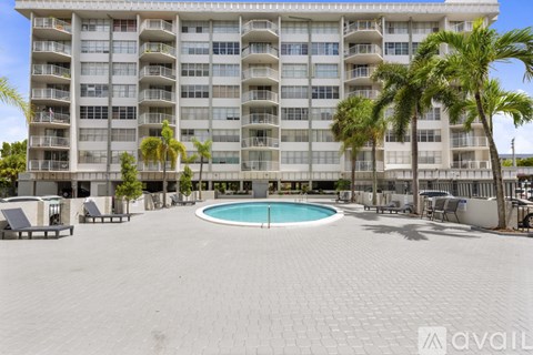 A large building with a pool in the middle of a courtyard.