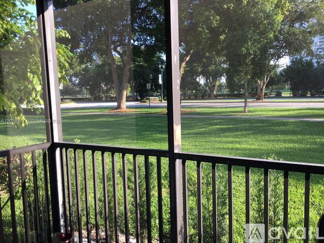 A view of a green lawn from a balcony.