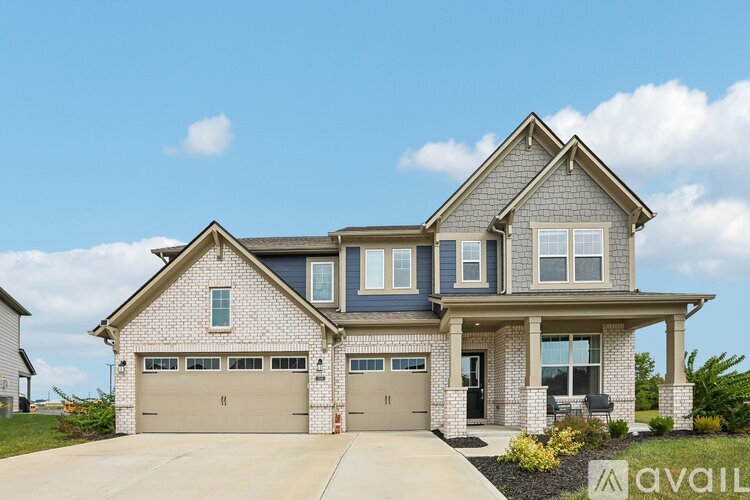 A two-story house with a garage is available for sale.