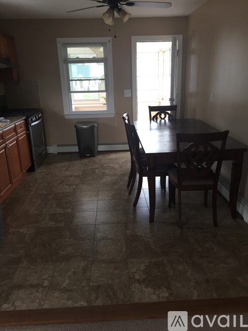 A kitchen with a table and chairs in the middle of the room.