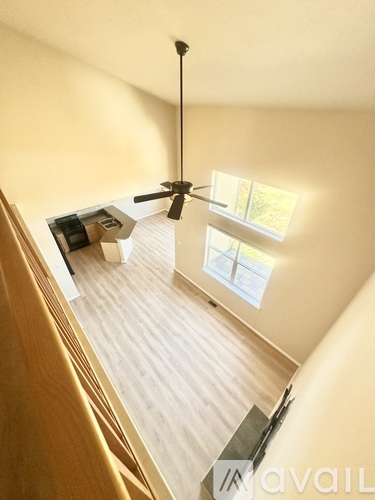 A room with a ceiling fan and a window letting in natural light.
