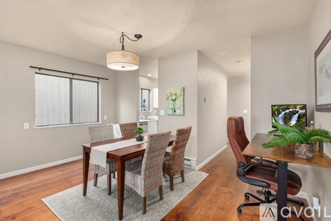 A dining room with a table and chairs.