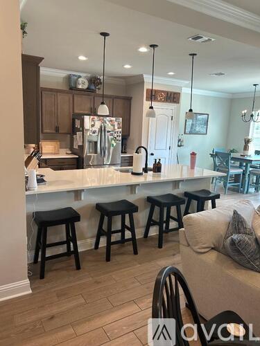 A kitchen with a bar and stools.