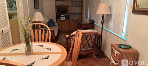 A dining room with a table and chairs.