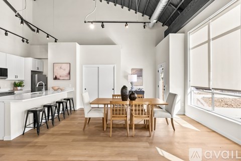 A modern kitchen with a dining table and chairs.