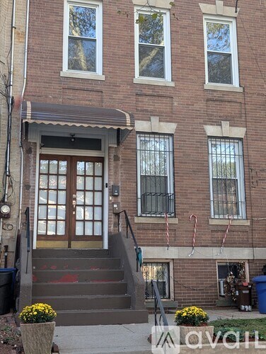 A brown building with a glass door and windows.