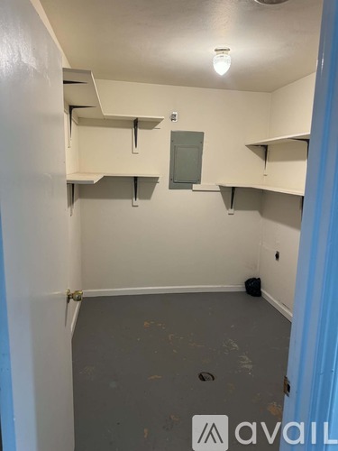 A room with a white wall and a blue door.