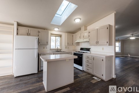 A kitchen with white appliances and cabinets.