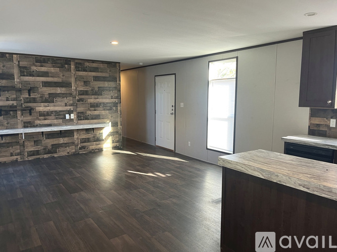 A room with wooden floors and a wooden wall.