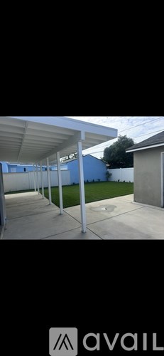 A white covered walkway with a blue wall in the background.
