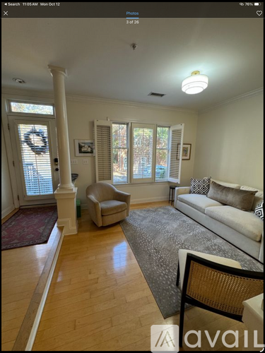A living room with a couch, chair, and pillows.