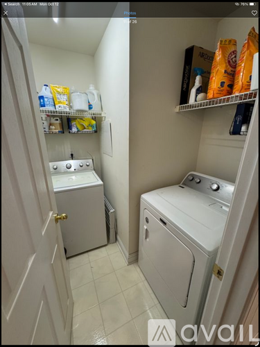 A small laundry room with a washer and dryer.