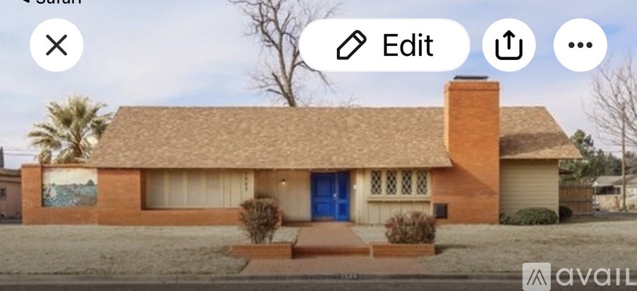 A house with a blue door and a brown roof.