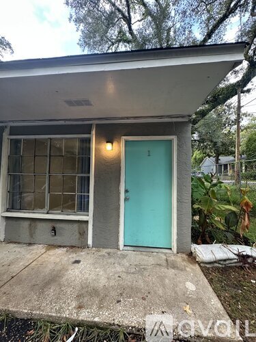A small house with a blue door and a window.
