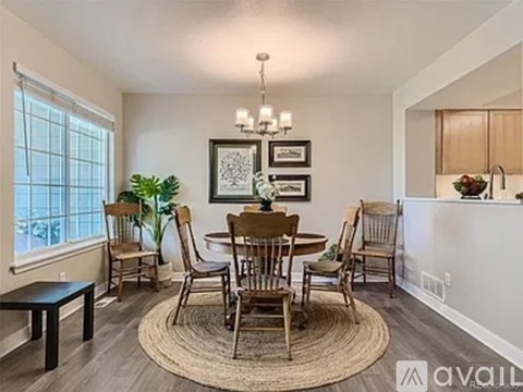 A dining room with a table set for six.