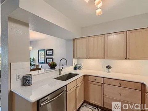 A kitchen with wooden cabinets and a white countertop.