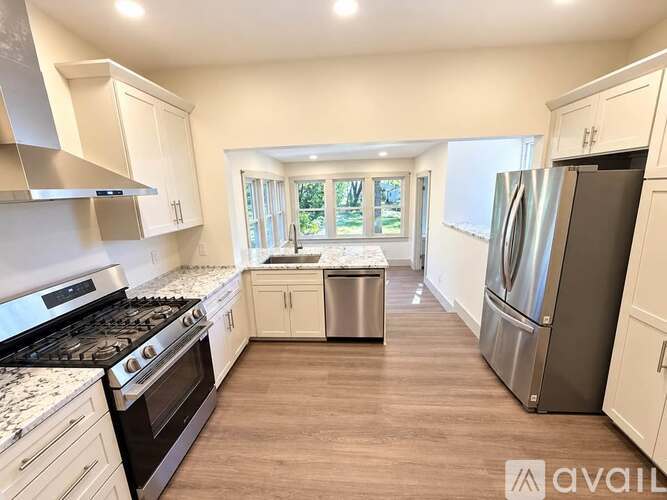 A kitchen with a stove, oven, and refrigerator.