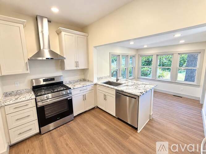 A kitchen with a stove top oven and a sink.
