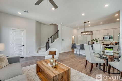 A modern living room with a wooden coffee table in the center.