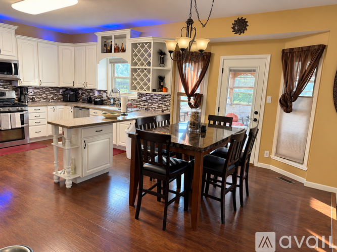 A kitchen with a table and chairs in the middle of the room.