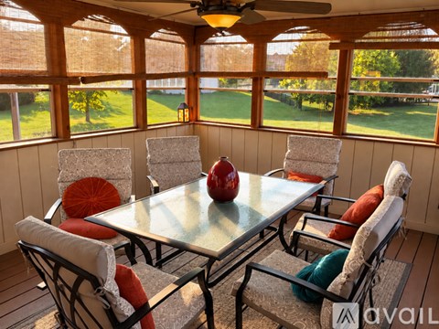 A table with chairs and a red apple on it.