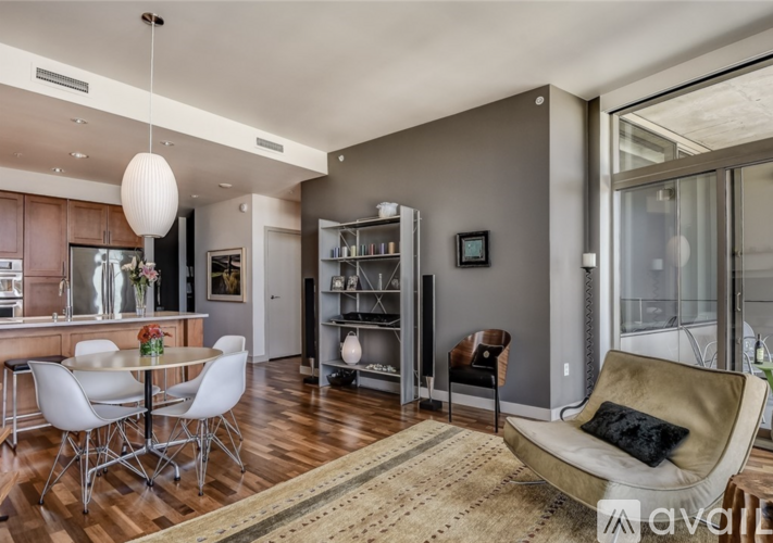 A modern living room with a dining table and chairs.