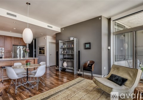 A modern living room with a dining table and chairs.