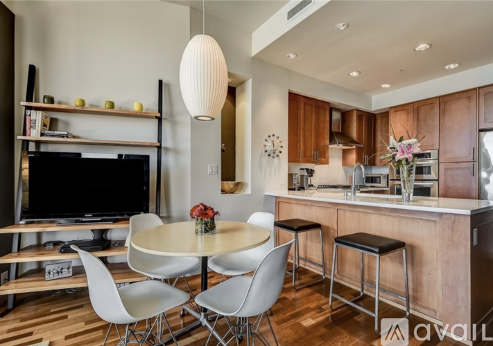 A modern kitchen with a dining table and chairs.