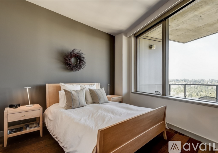 A bedroom with a large bed and a window overlooking the outdoors.
