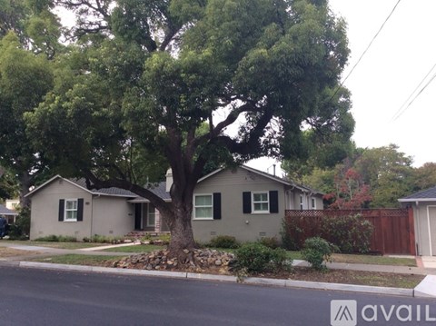 A house with a tree in front of it.