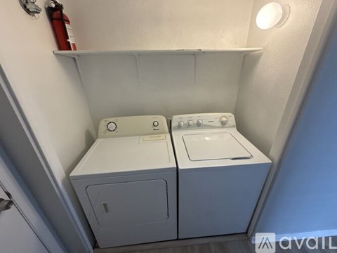 A small laundry room with a washer and dryer.