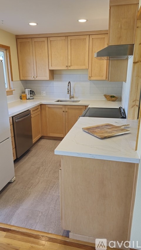 A kitchen with wooden cabinets and a white countertop.