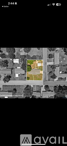 A satellite image of a house surrounded by trees.