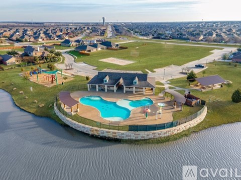 A bird's eye view of a residential area with a swimming pool and a playground.