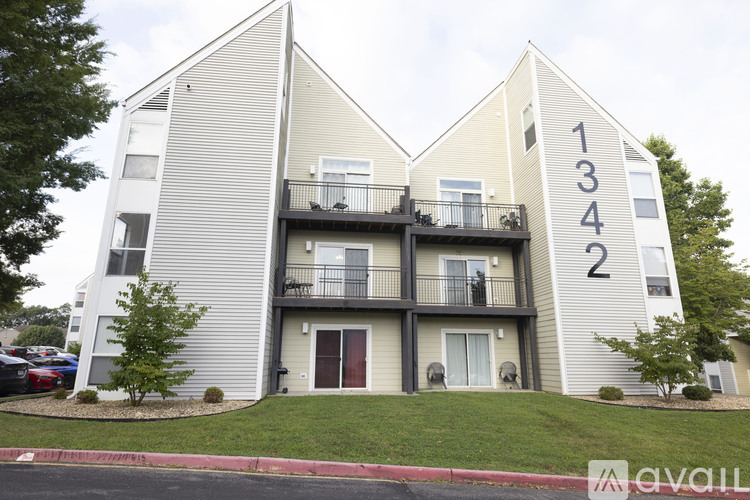 A modern two-story apartment building with balconies and doors.