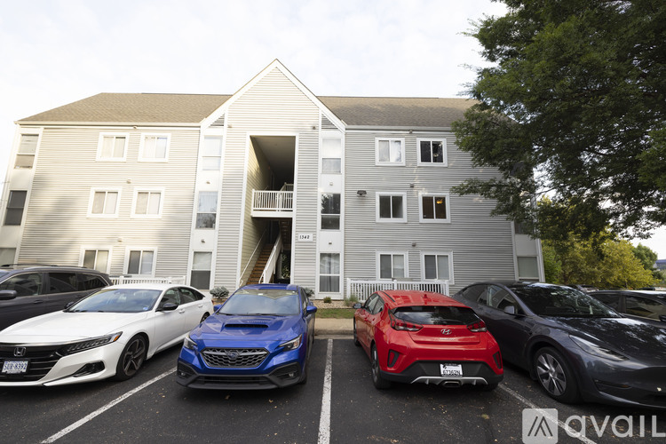 A row of cars parked in front of a building with a sign that says "available".