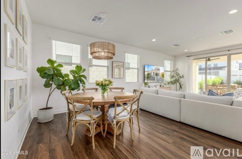 A dining room with a wooden table and chairs.